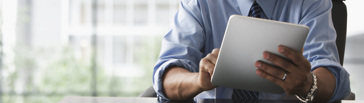 Businessman looking over electronic tablet