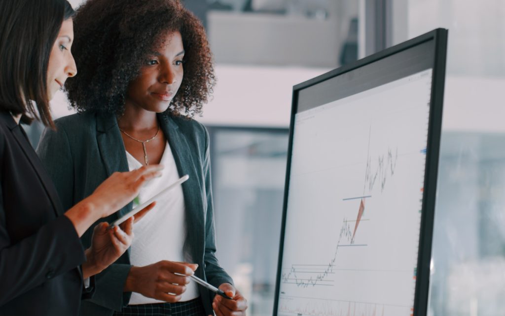 Two people looking at data chart with upwards trend