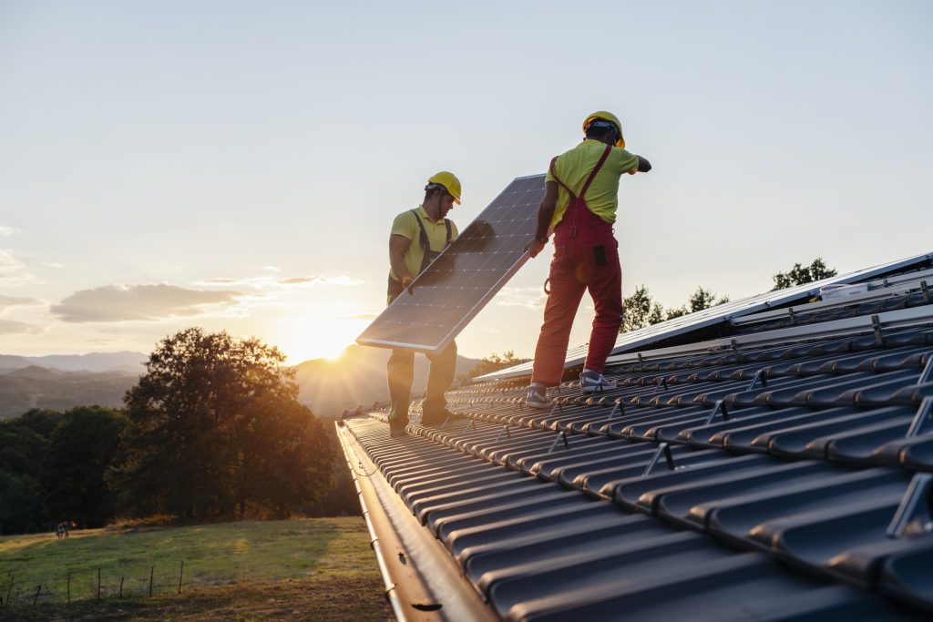 Workers installing solar panels