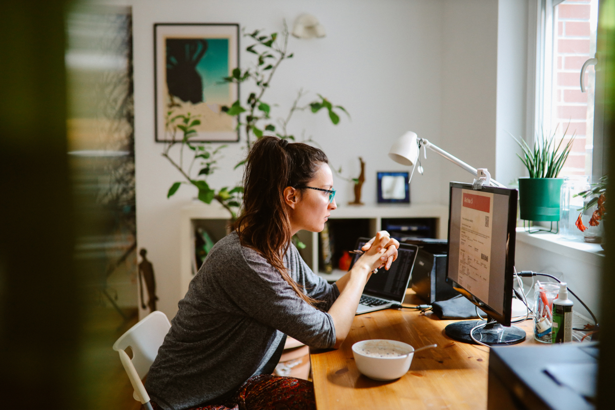 WOman working from home looking at computer screen