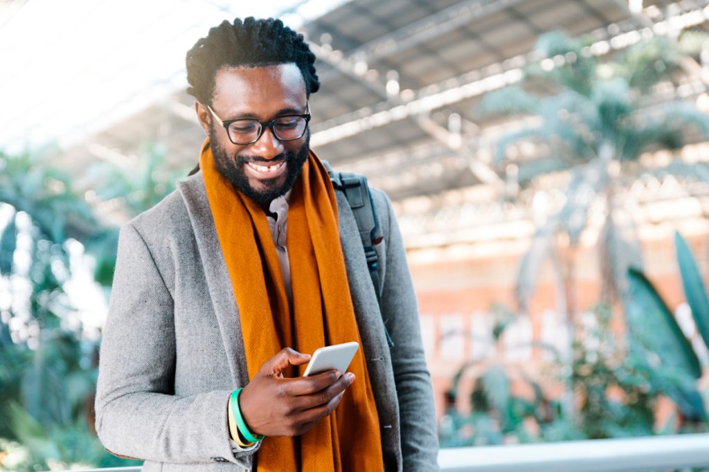 smiling business person reads content on mobile device