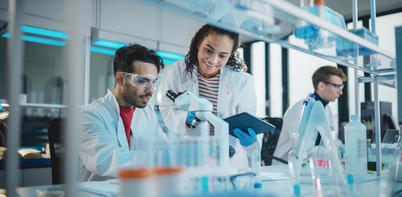 Young Scientists Using Microscope in laboratory