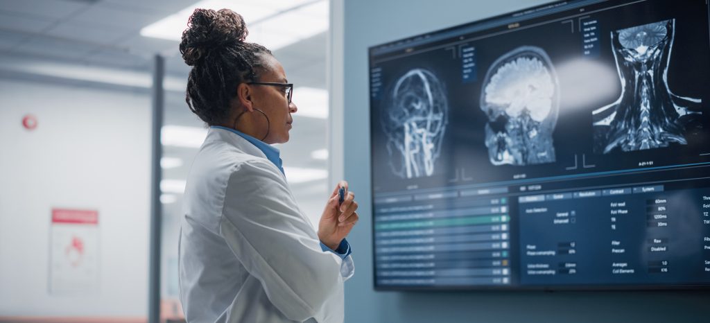 female black medical professional studying scans