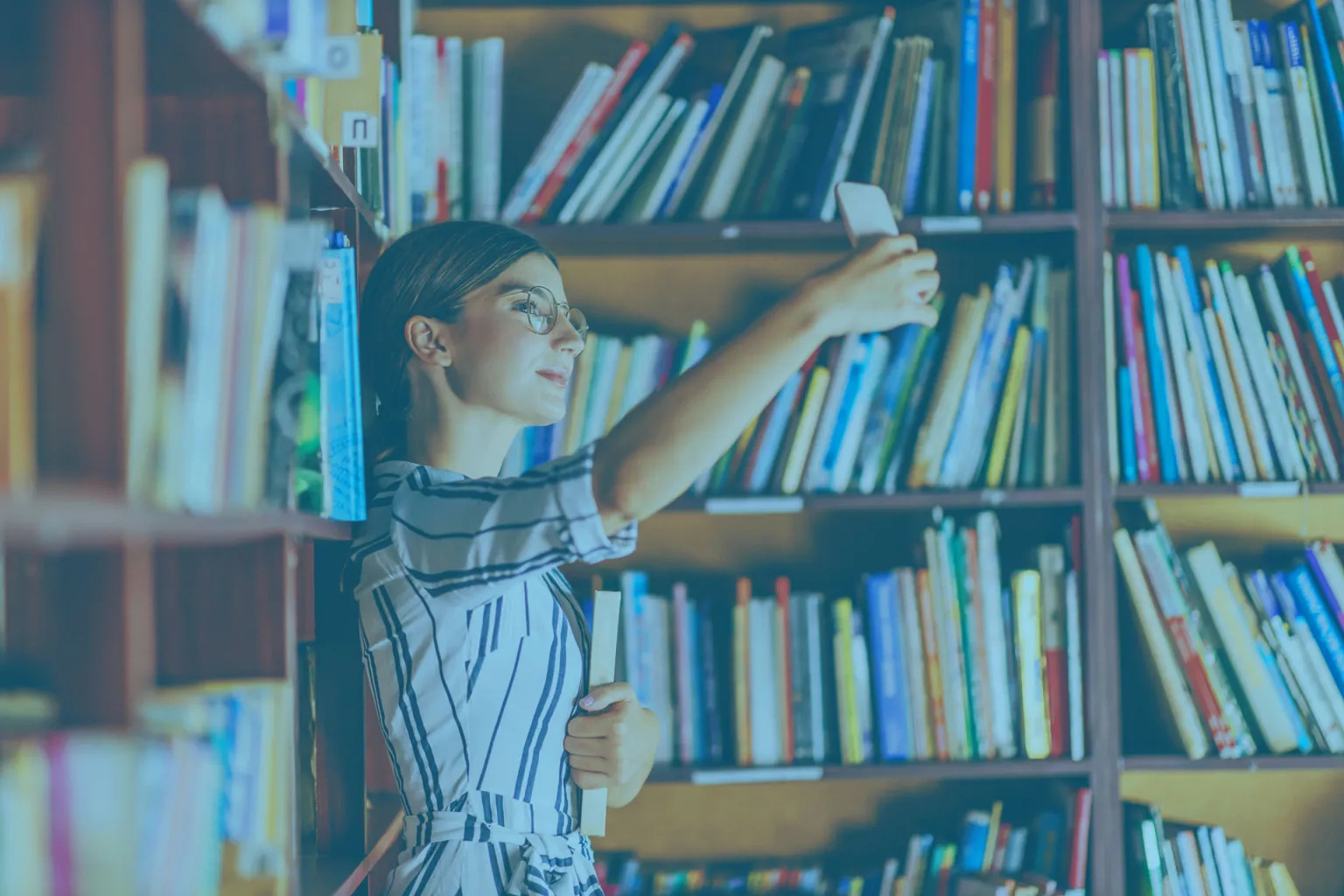 Woman in library taking a selfie