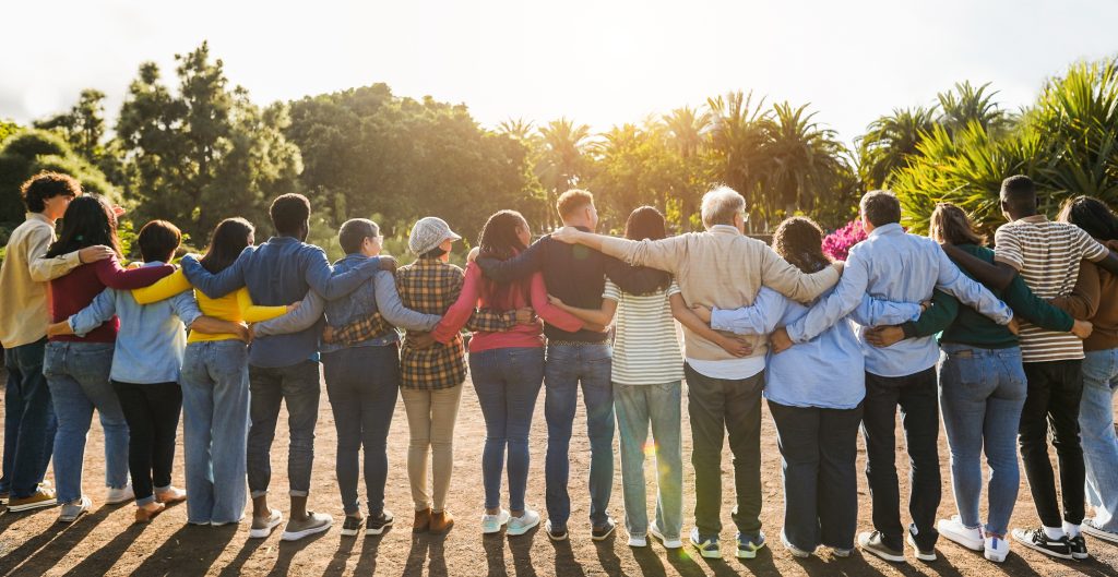 Diverse group of people hugging in arms