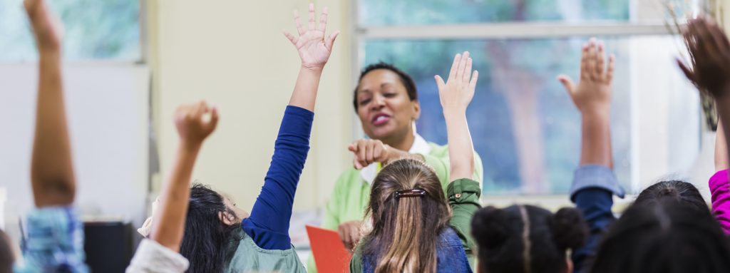 Teach pointing to elementary students raising their hands