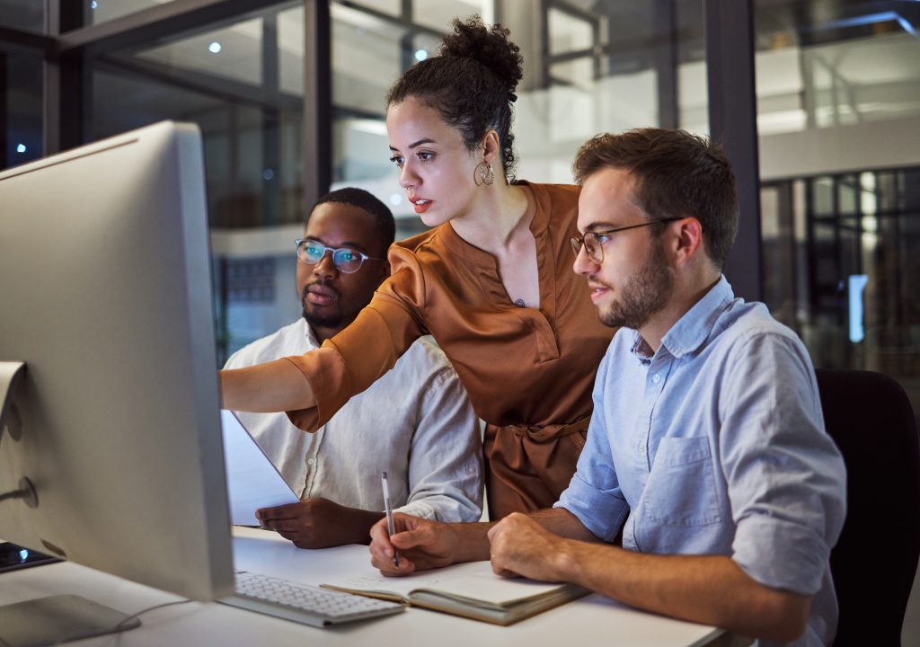 Learning, computer and training business interns in night office with manager, boss and leadership help
