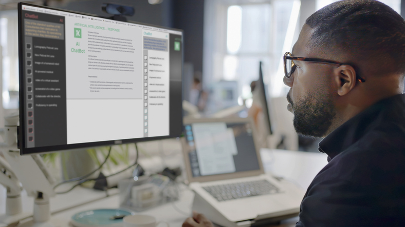 man’s face looking into a computer screen with an ai chatbot