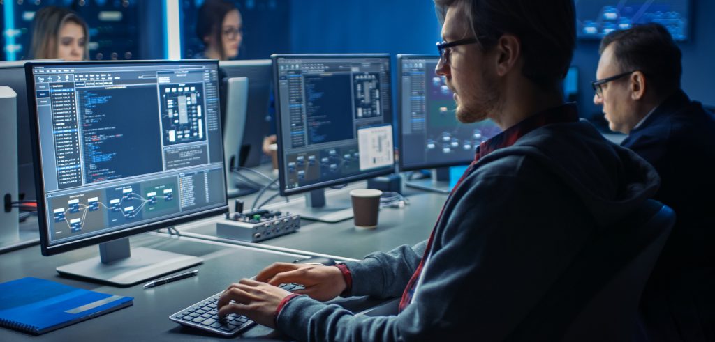 Male IT Programer Working on Desktop Computer in Data Center System