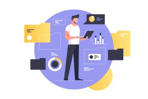 man working on laptop with documents and data