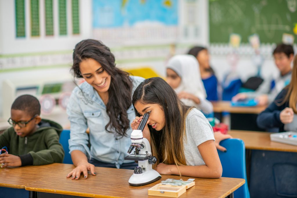 students using a microscope in class for science