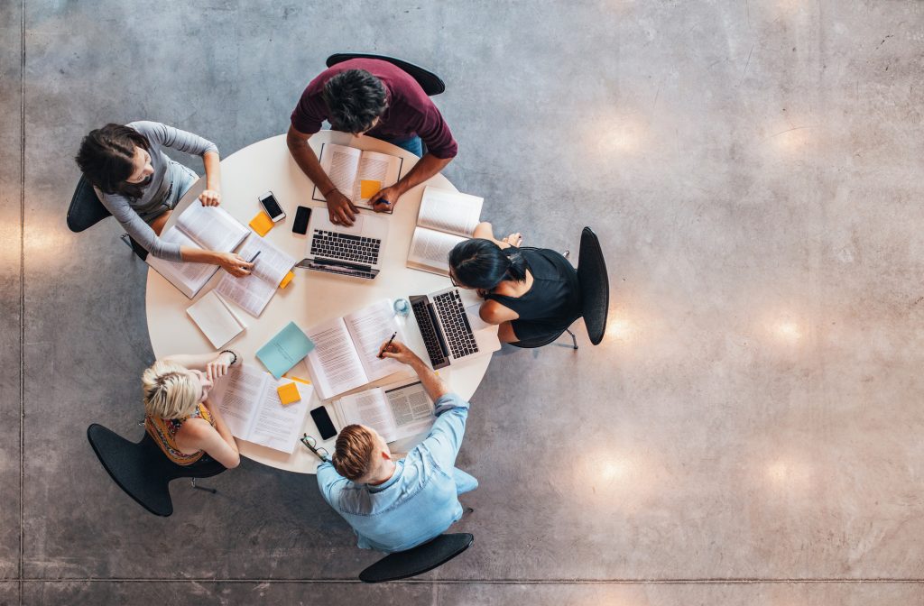 students working and studying at a desk