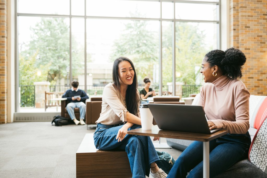 two students working on laptop in university