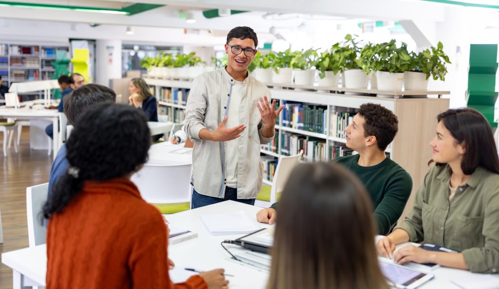 students in college university library discussing topics