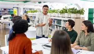 students in college university library discussing topics