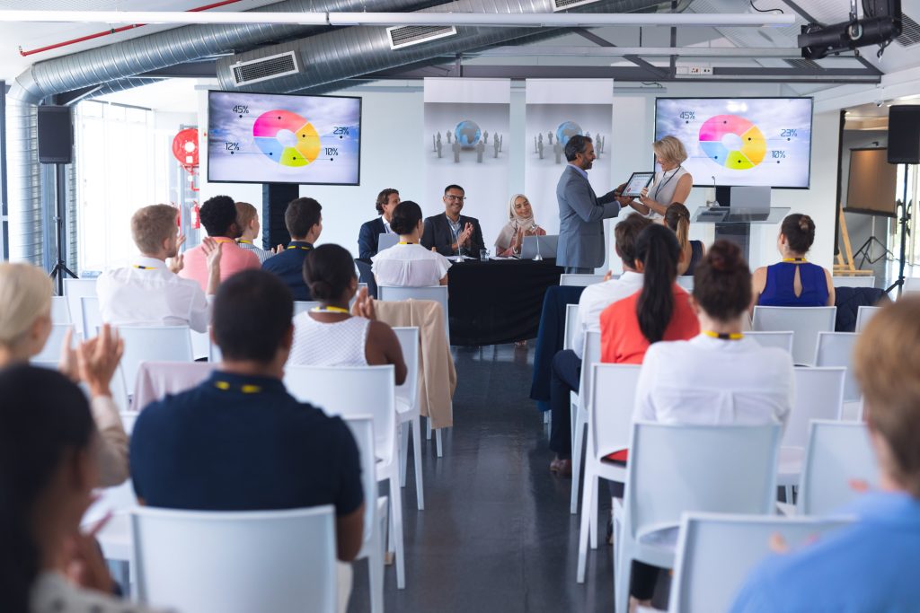 workers at an event watching presentation