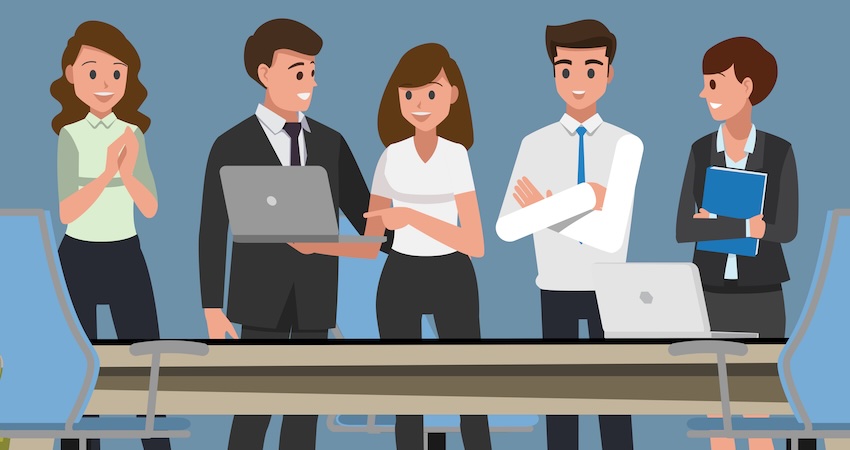 employees standing around desk working